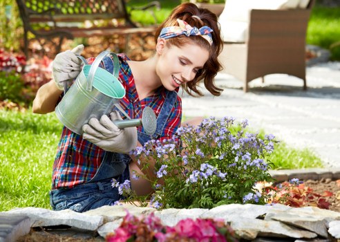 Gardener inspecting a residential garden in Wanstead
